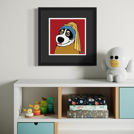 Dog with headscarf and expressive eyes—framed parody of Girl with a Pearl Earring set against bold red backdrop, staged above white shelf with stacking toys, patterned boxes, and bird-like figurine. Giclée print, 18x18cm from Nessy Pop Art.