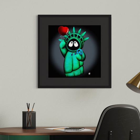 Framed colorful artwork of Hoodie Boy resembling the Statue of Liberty holding a heart and peace symbol on a dark background on a wall above a desk.