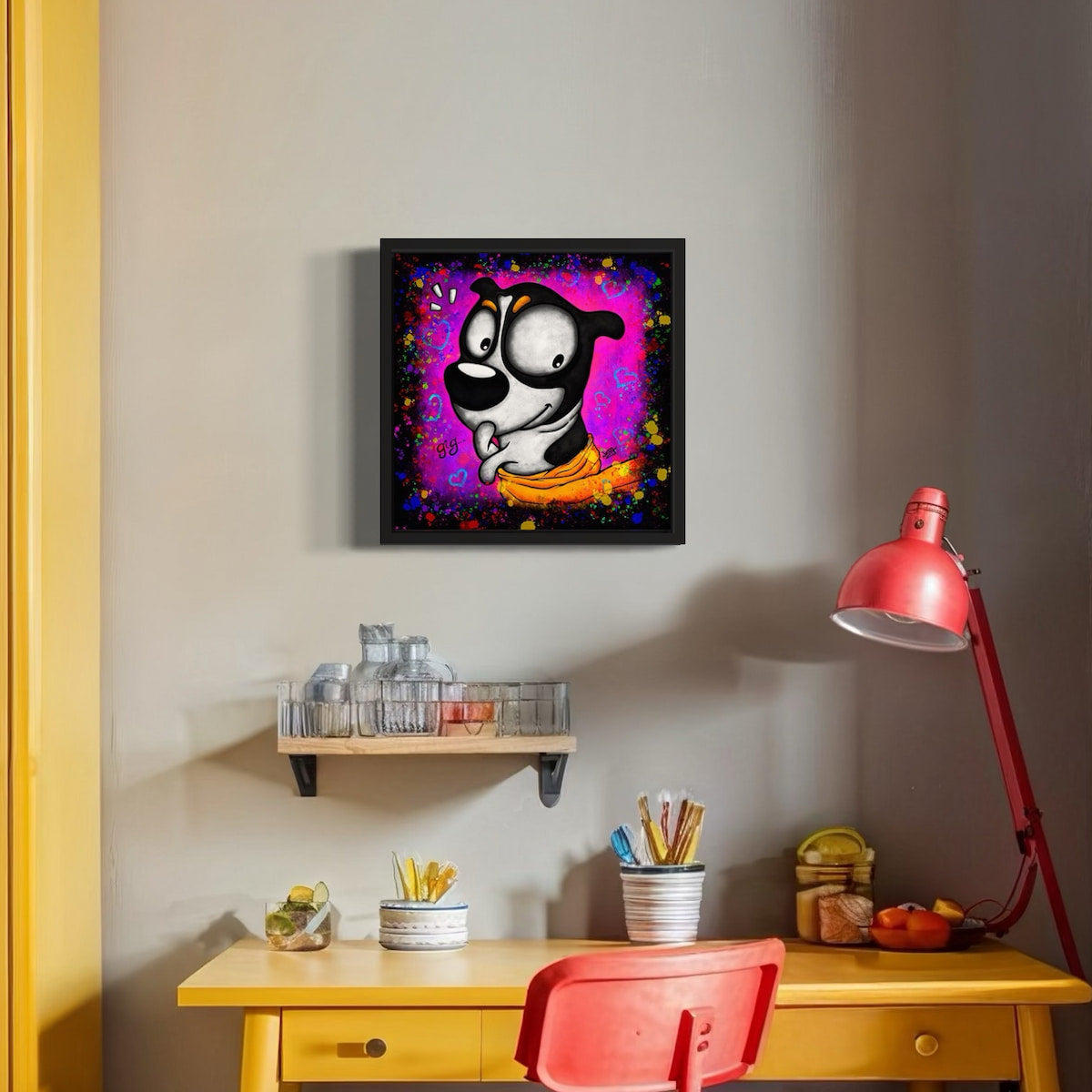 Framed colorful artwork of a dog in a towel fresh from the bath and a naughty smirk. Hung on a wall above a desk with a red chair and lamp.