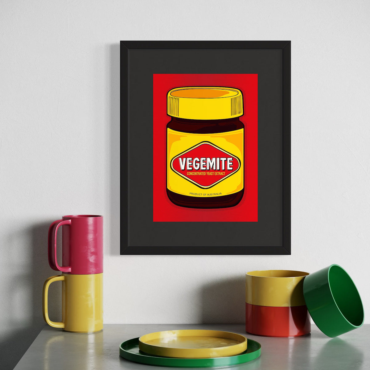 Vegemite in full pop—yellow lid, red diamond, and Aussie pride on blast. A4 giclée from Nessy Pop Art, framed above colour-matched mugs and bowls in red, green, and yellow. A national icon styled for the shelf.