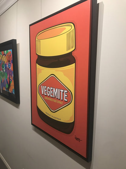 Vegemite in full pop—yellow lid, red diamond, and Aussie pride dialed to eleven. Framed canvas, 100×75cm from Nessy Pop Art, signed and mounted beside a splash of abstract colour. A national icon with gallery-grade swagger.