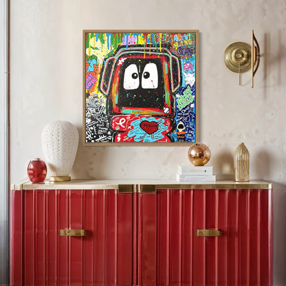 Colorful painting of Hoodie Boy surrounded by elements depicting elements of bullying on a wall above a red cabinet with decorative items.