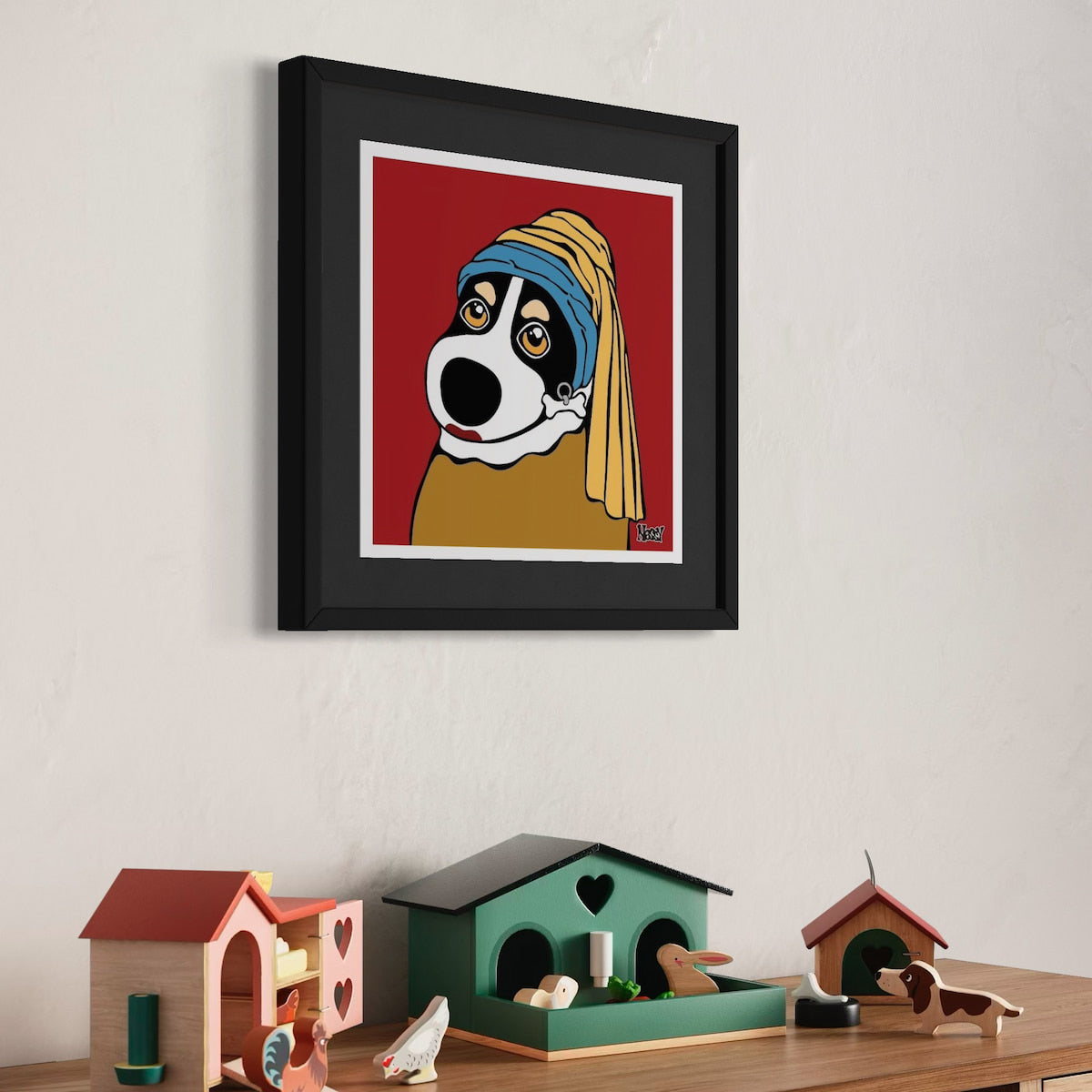 Dog with headscarf and yellow garment—framed parody of Girl with a Pearl Earring above shelf of colorful house-shaped decor and figurines. Red backdrop adds pop-art charm. A Giclee print, 30x30 cm from Nessy Pop Art