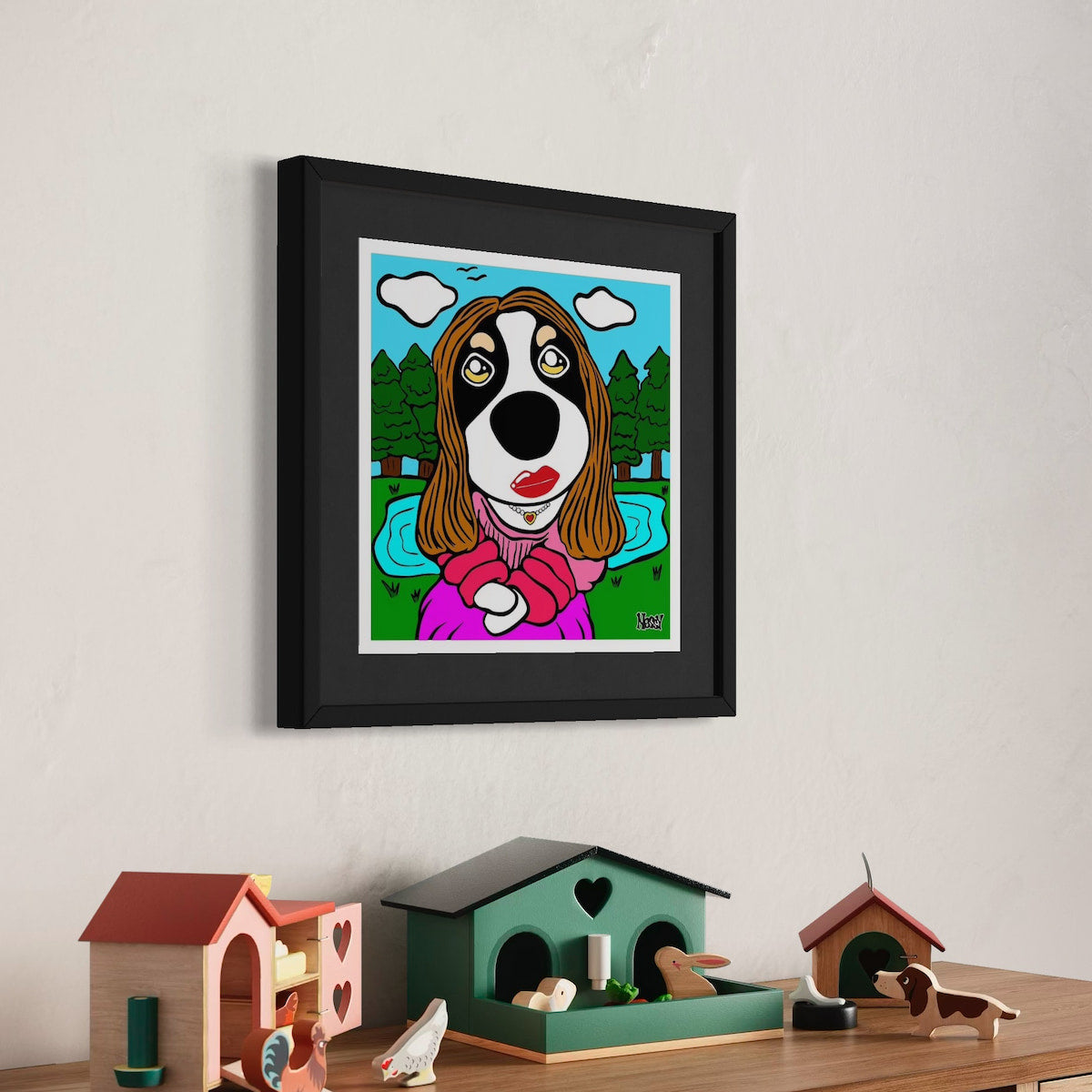 Framed cartoon dog portrait in pink outfit with red lips and long brown hair—hung above shelf of birdhouses and animal figurines, set against scenic pond and forest sky. A playful nod to Mona Lisa, reimagined by Nessy Pop Art.