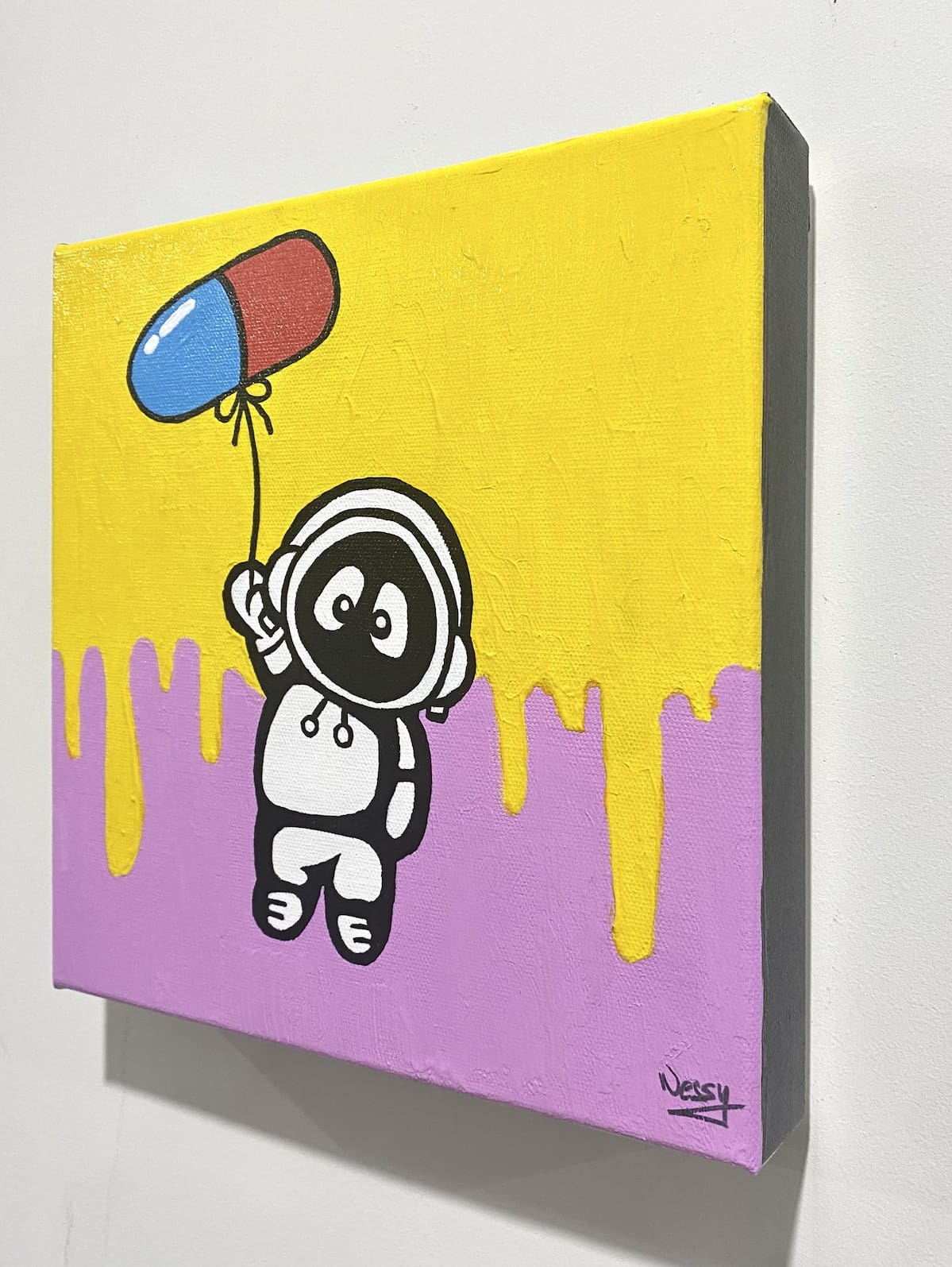 A colorful painting of Hoodie Boy being lifted up by a balloon in the shape of a pill.