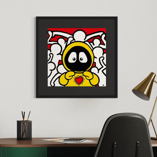 Framed colorful artwork of Hoodie Boy in yellow and Keith Haring figures in the background, on a wall above a desk.