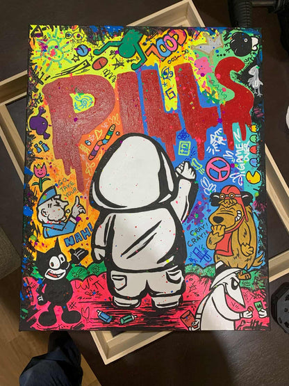 Colorful artwork of Hoodie Boy spray painting the word 'PILLS' with various characters and text on a dark surface