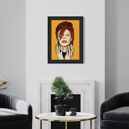 Framed artwork of David Bowie on an orange background in a living room setting.