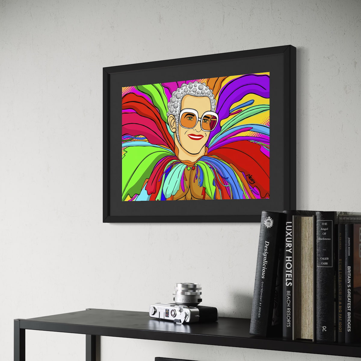 Stylized cartoon portrait of Elton in his iconic chicken suit—white-framed glasses, silver head dress, and multicolored feathered costume set against vibrant pop-art backdrop of red, green, purple, yellow, and blue. Giclée print, A3 from Nessy Pop Art.