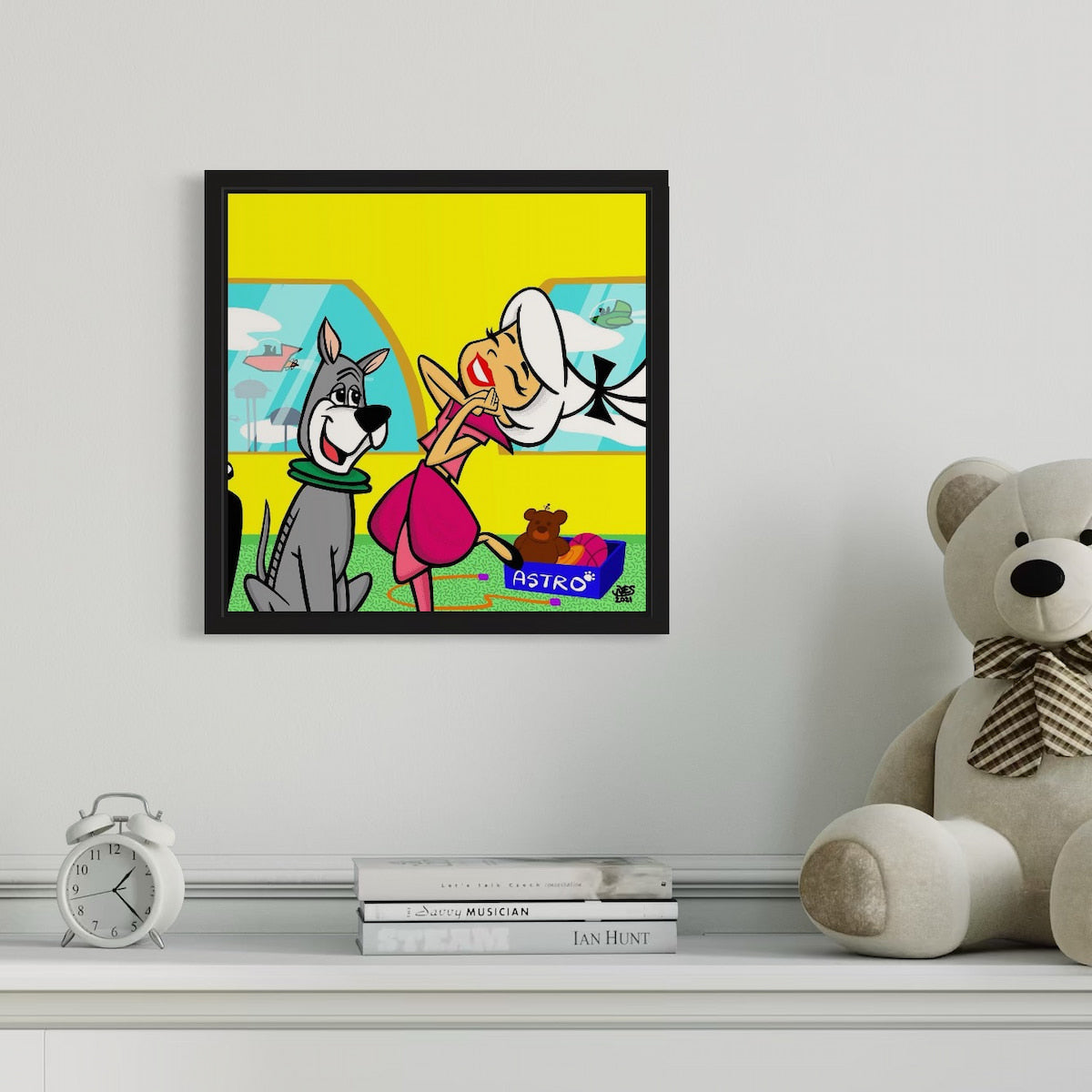 Framed cartoon artwork on a shelf with a teddy bear and books.