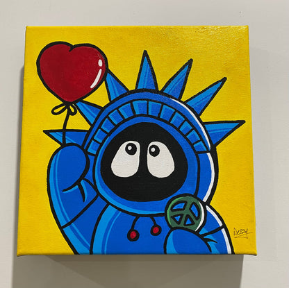 Painting of Hoodie Boy as the Statue of Liberty with a heart balloon and peace symbol, with a yellow background, on a white wall.