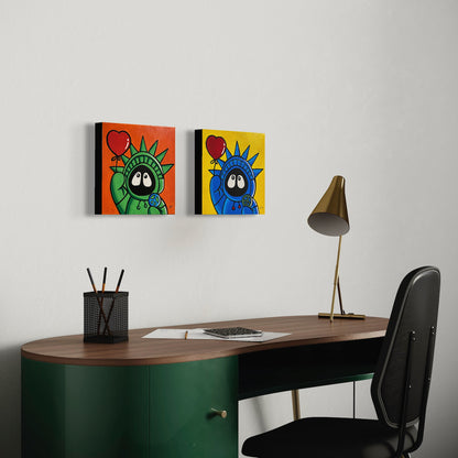 Desk with two colorful wall art pieces above it on a light gray wall.