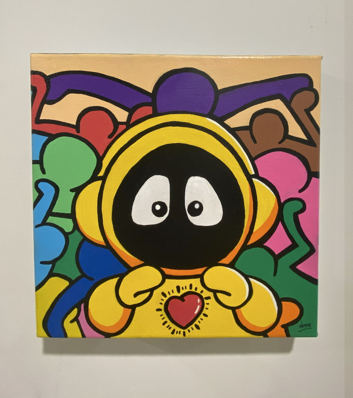 Colorful painting of Hoodie Boy in yellow with a heart on his chest and Keith Haring characters surrounding him.