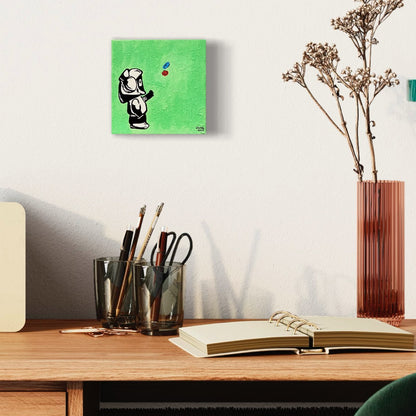 Painting of Hoodie Boy reaching for pills with a green background, above a desk with a notebook and vase