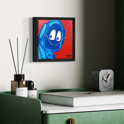Framed painting of Hoodie Boy dressed as Salvadore Dali above a desk with books and a clock.