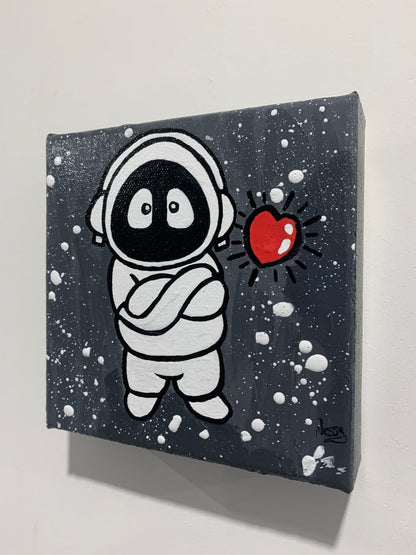 Painting of Hoodie Boy, arms folded, with a floating heart, viewed from the side on a white wall.