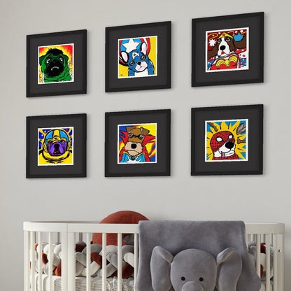 Colorful dog portraits wearing superhero costumes in black frames on a wall above a crib with toys.