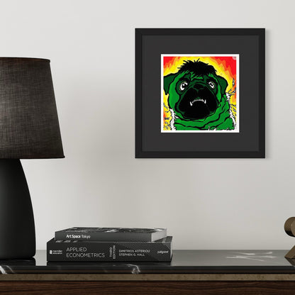 Framed artwork of a green pug dressed as the incredible hulk on a wall above books and a lamp.